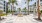 a courtyard with palm trees and buildings