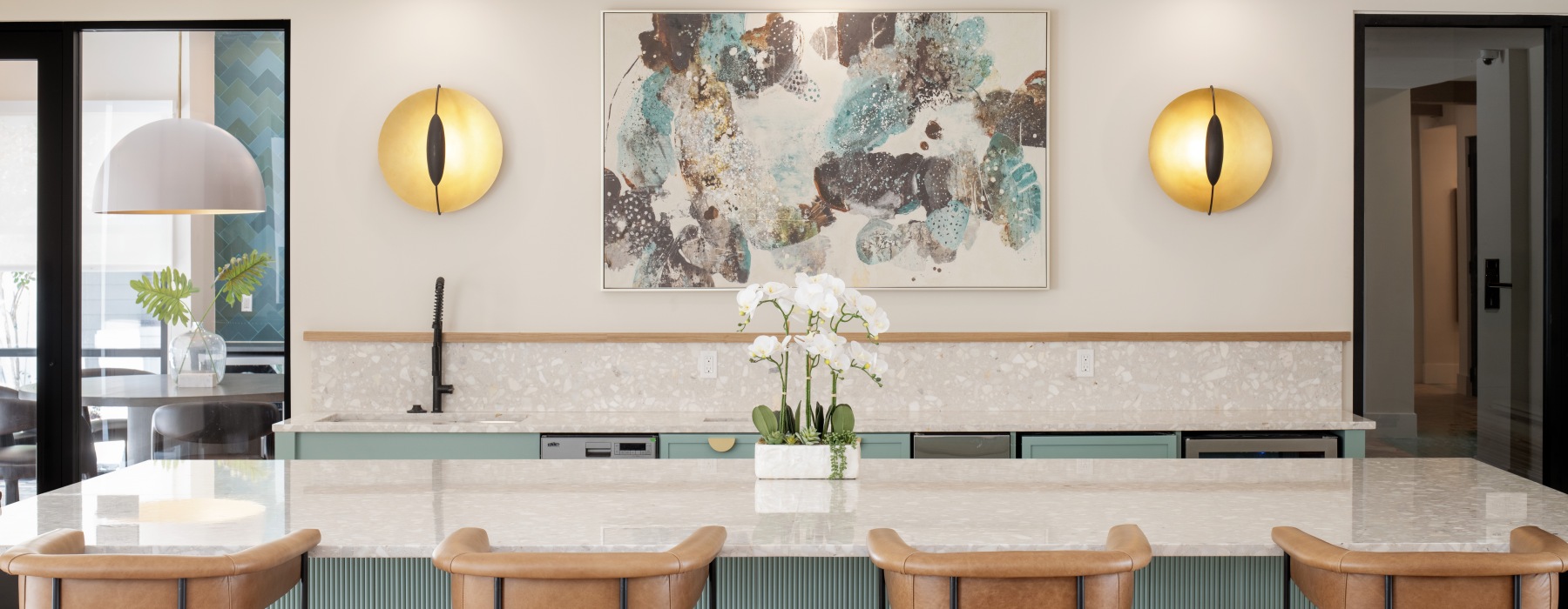 a kitchen with a bar and chairs