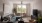 a living room with a green couch and a fan