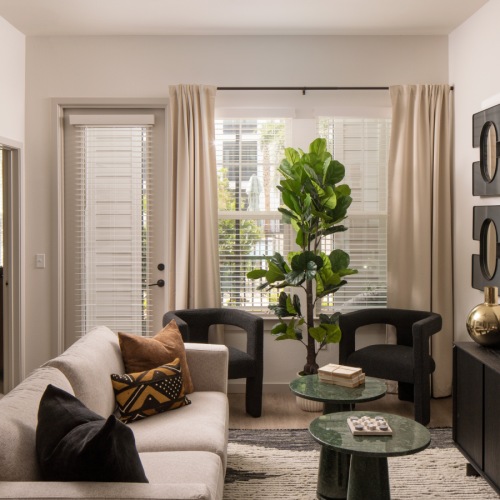 a living room with a rug and a table